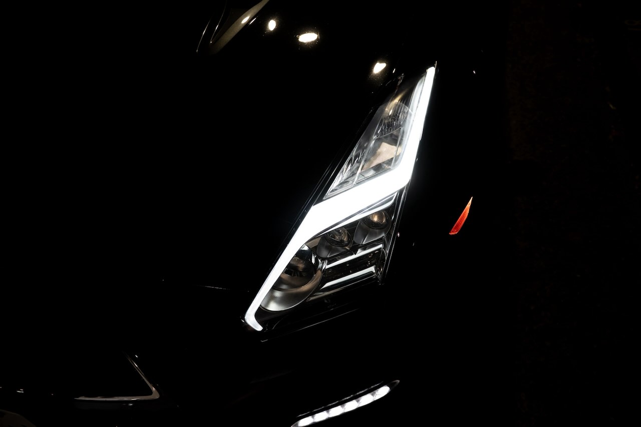 Close-up of a Nissan GT-R R35 headlight and daytime running light at night in Tokyo