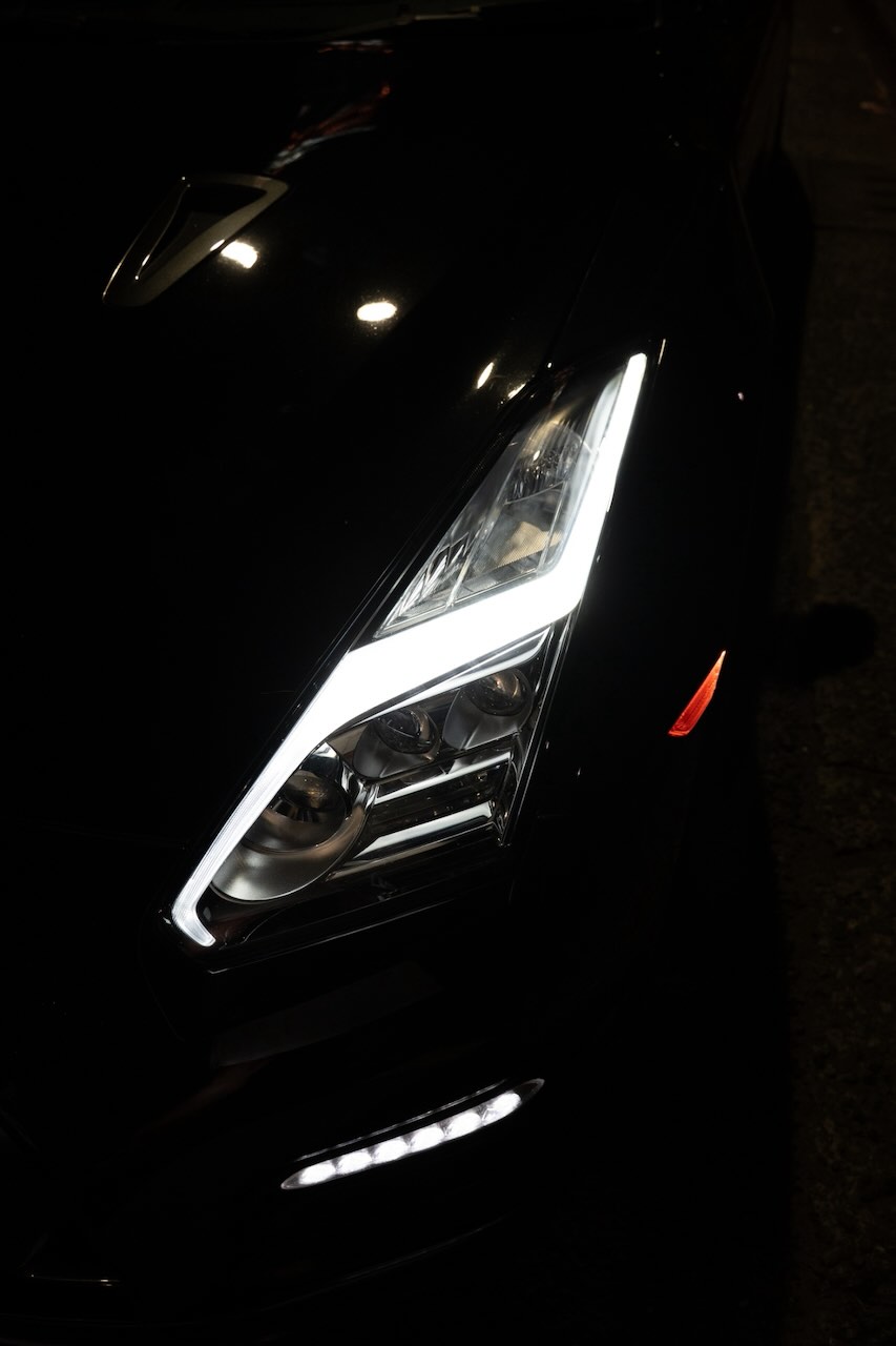 Detail of the Nissan GT-R R35 headlight cluster at night